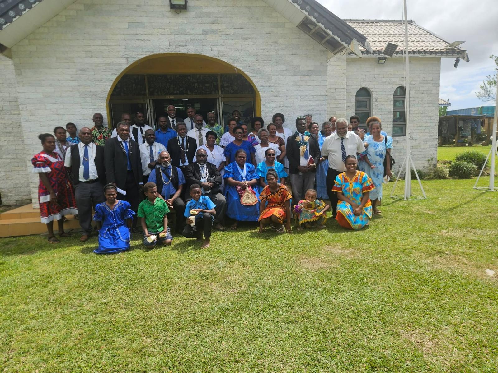 The congregation and session of Klivtrn Harvest Presbyterian Church gathered with Pastor Kalmara Firiam in front of the church in Port Vila