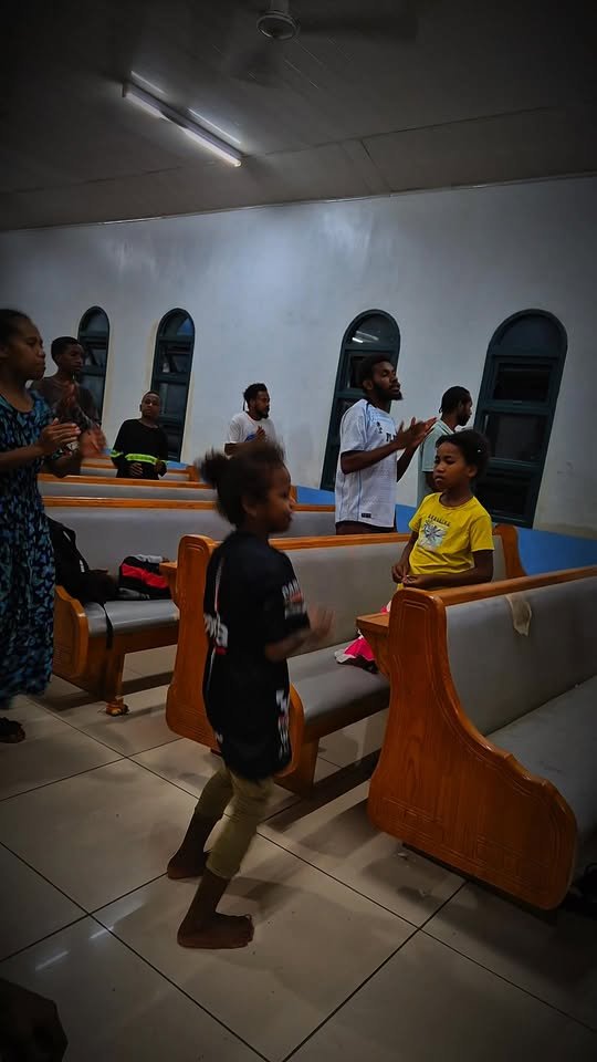 Children and young people clapping and joining in during a service at Klivtrn Harvest